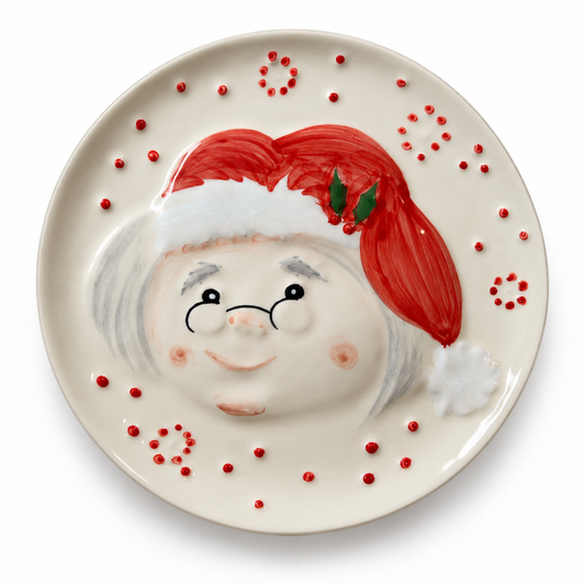 Mrs. Claus Dessert Plate — 19.5 cm

Bring a little Christmas charm to the table with Mrs. Claus. Handmade and hand-painted in Portugal, this earthenware dessert plate features her smiling face, delicate spectacles and a bright red hat with holly details. Raised red dots and a glossy cream finish complete the festive design.

Perfect for a slice of Christmas cake, holiday cookies or a sweet treat shared with family.

• Material: Earthenware
• Diameter: 19.5 cm
• Weight: Approximately 375 g
• Handmade